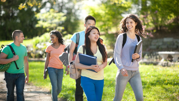 Teenagers walking with books and backpacks